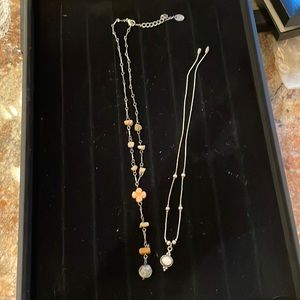 Two necklaces. One sterling and the other costume jewelry. Very fashionable